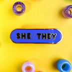 She/They Pronoun Plaque Enamel Pin - Undercover Otter - Pins - Kitty With A Cupcake - Black