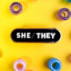 She/They Pronoun Plaque Enamel Pin - Undercover Otter - Pins - Kitty With A Cupcake - Black