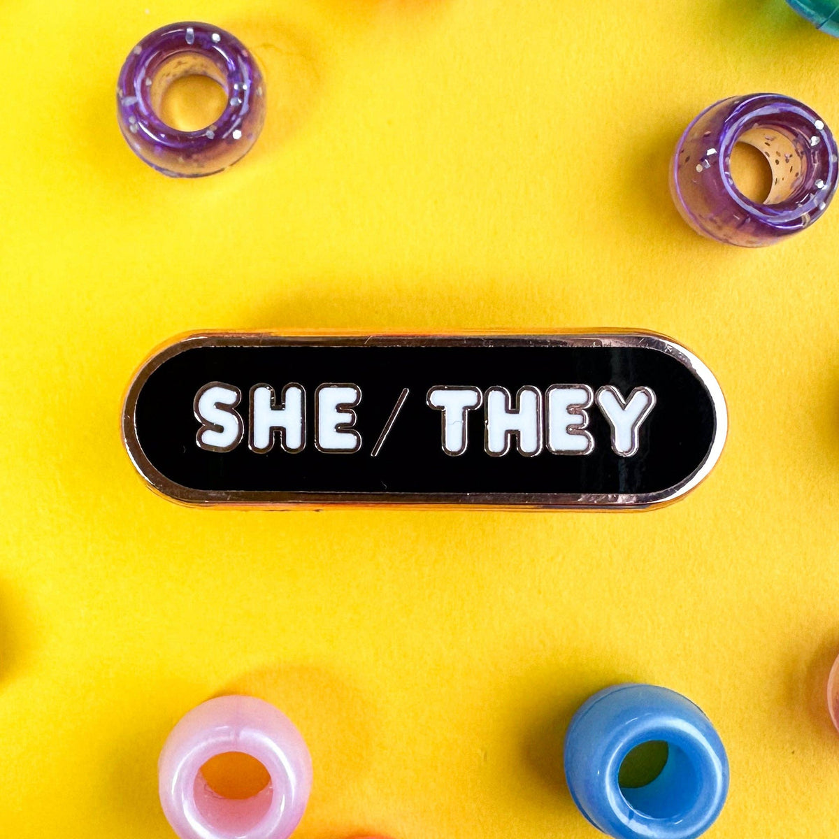 She/They Pronoun Plaque Enamel Pin - Undercover Otter - Pins - Kitty With A Cupcake - Black